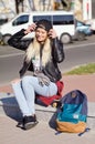 Lady girl happy smiles, sits skateboard Royalty Free Stock Photo