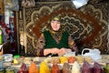 Lady with gold teeth selling spices in front of carpet at market in Baku, capital of Azerbaijan