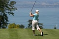 Lady golf swing at Leman lake Royalty Free Stock Photo