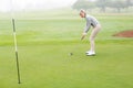 Lady golfer on the putting green Royalty Free Stock Photo