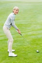 Lady golfer on the putting green Royalty Free Stock Photo