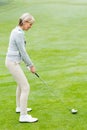 Lady golfer on the putting green Royalty Free Stock Photo