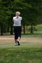 Lady golfer in white Royalty Free Stock Photo