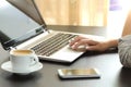 Lady hand browsing a laptop at home