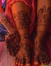 A lady hand & feet with indian heena mehandi in indian weddings