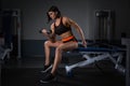 Lady Hand lift up dumbbell one hand at Gym for bodybuilder. in Seated Dumbbell Concentration Curls Action. Halthy concept. Royalty Free Stock Photo