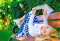 Lady happy face enjoy reading. Time for self improvement. Girl lay bench park relaxing with book, green nature Royalty Free Stock Photo