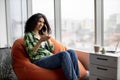 Lady having conversation on phone with coworkers indoors Royalty Free Stock Photo