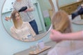 Lady having hair dried in hairdressers