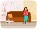 Lady in headpones sitting on couch, listening to music and browsing social media on smartphone Royalty Free Stock Photo