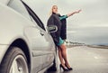 Lady in high heel shoes with broked car on the highway
