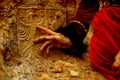 Lady in historic dress beside heraldic sign carved in stone. Vintage effect.