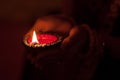 A lady holding Diya for Diwali Celebration