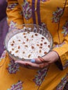 Lady holding kheer, rice pudding, dessert or sweet in hands. Food photography.