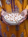 Lady holding kheer, rice pudding, dessert or sweet in hands. Food photography.