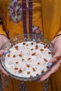 Lady holding kheer, rice pudding, dessert or sweet in hands. Food photography.