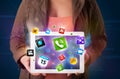 Lady holding a tablet with modern colorful apps and icons