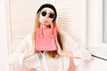 Lady holds pink purse with handle as sad smiley. Royalty Free Stock Photo