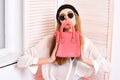 Lady holds pink purse with handle as sad smiley. Royalty Free Stock Photo