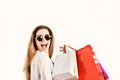 Lady holds red and beige shopping bags. Woman with packages.