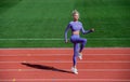 lady jumping in fitness sportswear. warm up on outdoor arena. training and workout. athletic female coach. woman sport