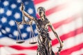 Lady Justice and American flag. Symbol of law and justice with U Royalty Free Stock Photo