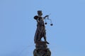 Lady justice at the Roemer in Frankfurt am Main symbolizes Justice with sword and scales