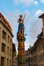 The lady justice statue with raised sword between buildings in Lausanne Royalty Free Stock Photo