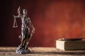 Lady Justicia holding sword and scale bronze figurine with book Royalty Free Stock Photo