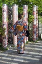 Lady in a kimono in front of a kimono forest in Kyoto