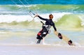 Lady Kite boarder entering the surf Royalty Free Stock Photo