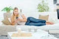 Lady layed on couch using cellphone