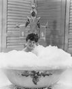 Lady of leisure soaks in a tub of bubbles Royalty Free Stock Photo