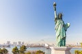 Lady liberty juxtaposed against Rainbow Bridge in Tokyo, Japan Royalty Free Stock Photo