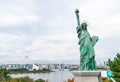 Lady liberty juxtaposed against Rainbow Bridge in Tokyo. Royalty Free Stock Photo