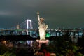 Lady liberty juxtaposed against Rainbow Bridge in Tokyo. Royalty Free Stock Photo