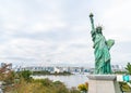 Lady liberty juxtaposed against Rainbow Bridge in Tokyo. Royalty Free Stock Photo