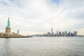 Lady Liberty Statue with Lower Manhattan Modern Buildings, Skyscrapers and Towers in Background. New York City, USA Royalty Free Stock Photo