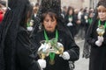 A lady lights her candle in the procession of the Brotherhood of the Virgin of Hope of Holy Week in Zamora, Spain.