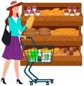 Lady looking at bakery in hypermarket. Woman with shopping cart chooses pastries at grocery store Royalty Free Stock Photo