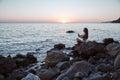 Lady in lotus position. Alone time and relaxation concept. Meditation and contemplation. Nature landscape, copy space