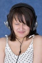 Lady make a wry face in earphones Royalty Free Stock Photo