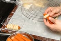 a lady making bread with sausages at home