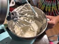Lady making buttercream in an electric mixer