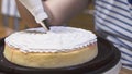 Lady making cream cake