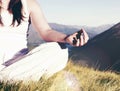 Lady meditating in lotus position on top of the mountain Concept