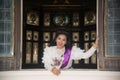 The lady in Middle Thai classical traditional dress suit posing indoor at old railway station building. Royalty Free Stock Photo