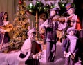 Group of ladies surrounded by the Christmas spirit playing the violin and singing