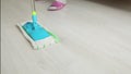 Lady mopping the kitchen floor with mop