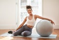 lady in morning workout session at home sitting with ball Royalty Free Stock Photo